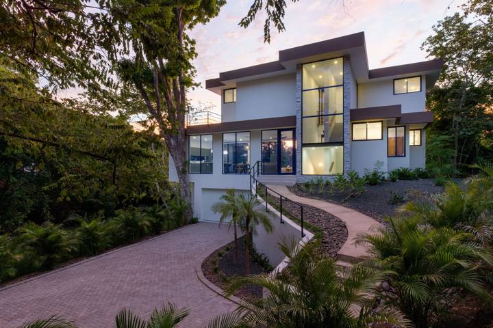 Front of the house at dusk with every window lit