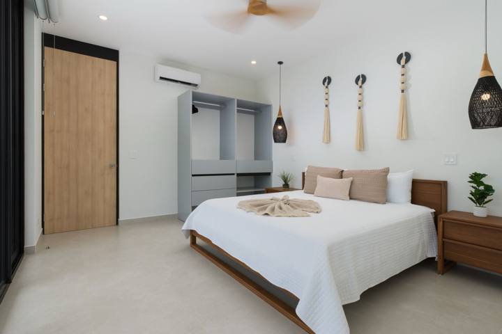 Upstairs king bedroom with open wardrobe and woven pendant lights