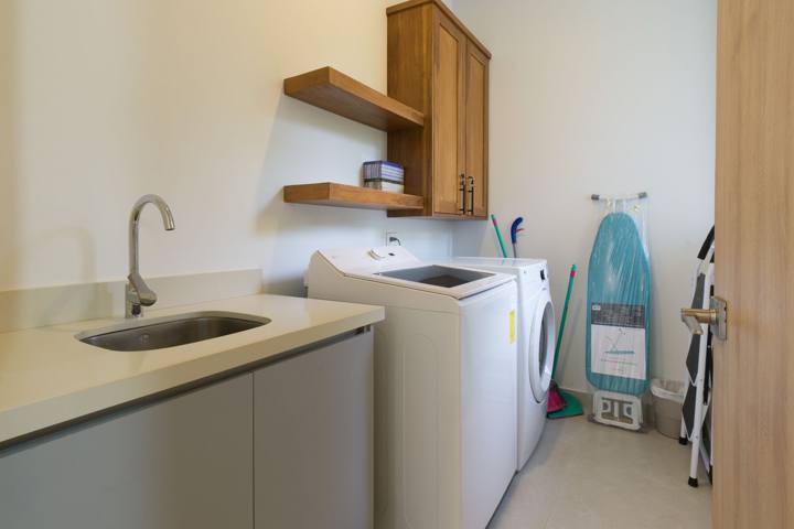 Laundry room with washer, dryer, sink and ironing board